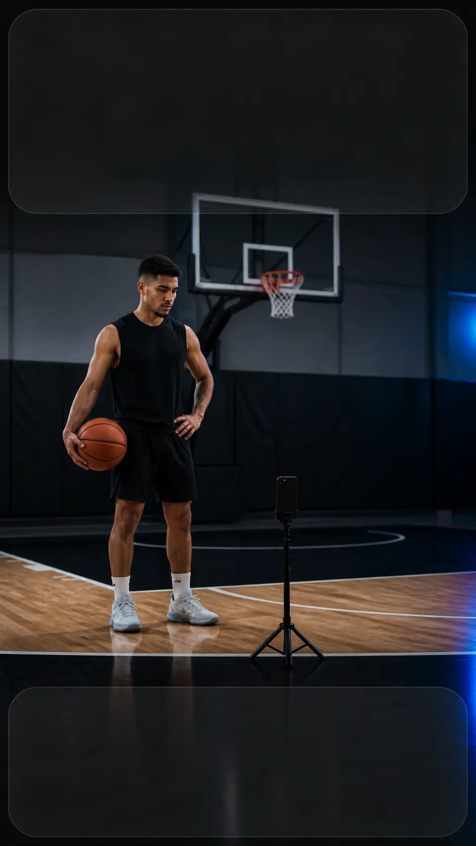 Basketball player preparing a solo workout beside a smartphone on a compact tripod